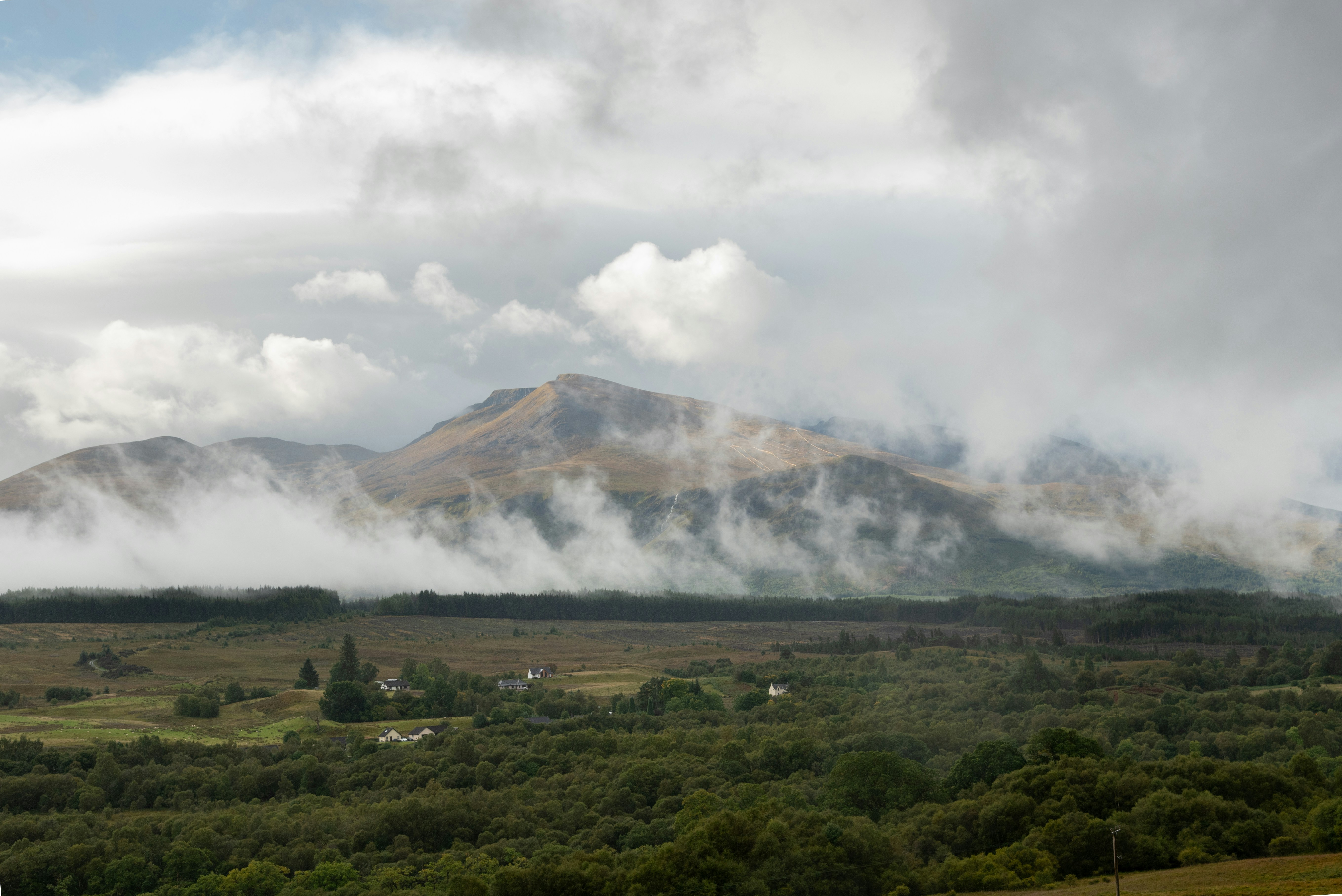 a view of a mountain range with clouds in the sky