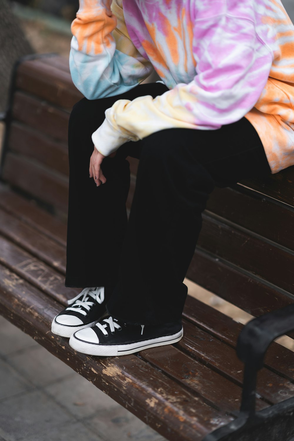 a person sitting on a bench with their feet crossed