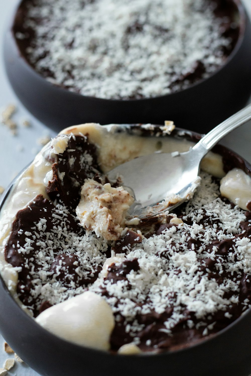 a bowl of dessert with a spoon in it