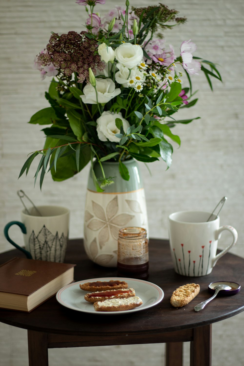 a table topped with a vase filled with flowers