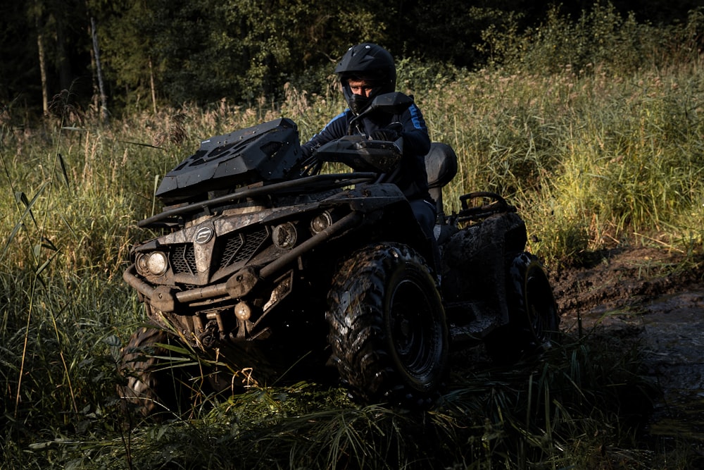 a man riding on the back of an atv