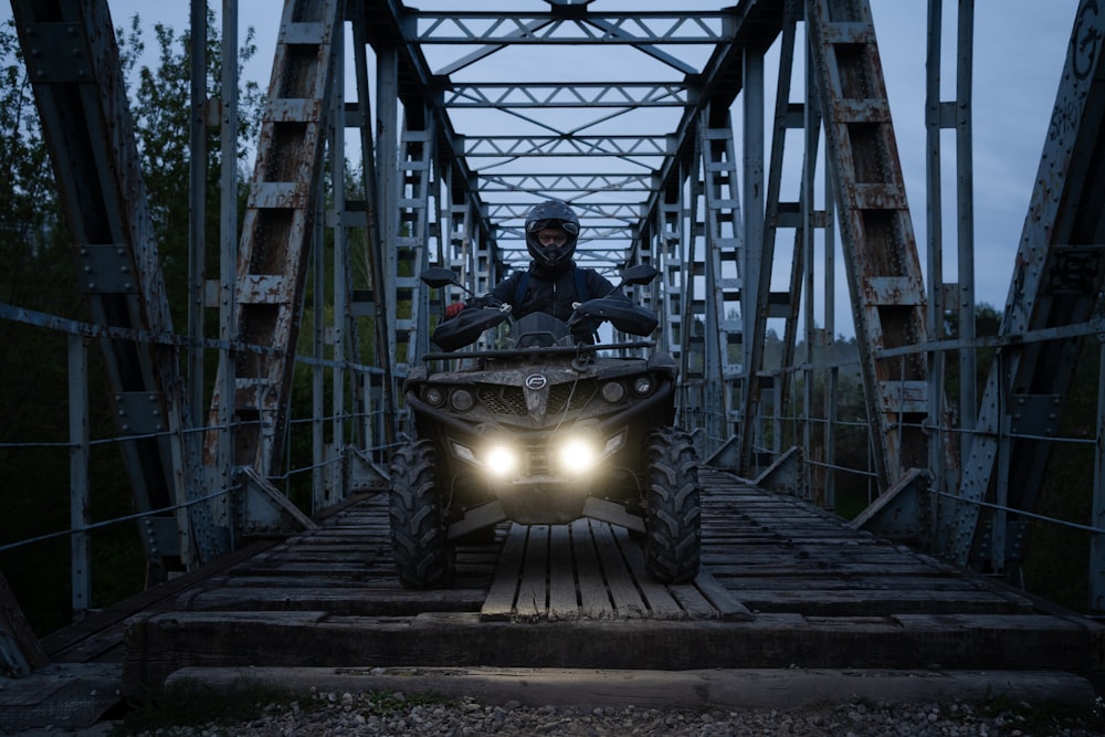 a man riding on the back of a four wheeler