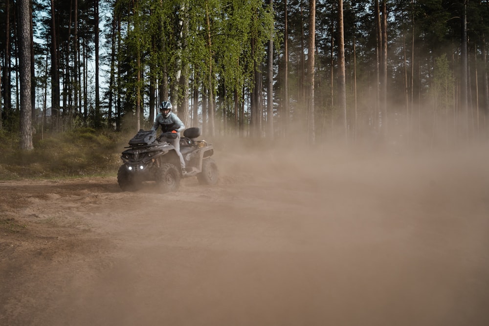 a person riding an atv on a dirt road