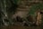 A natural scene featuring a rocky landscape with water gently cascading over the rocks. Lush green vegetation climbs up the rocks, contrasting with the dark, wet stone surface. The ambiance is serene and untouched, with earthy textures and moisture evident on the rocks and foliage.