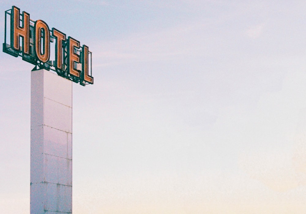 a large hotel sign on top of a tall building