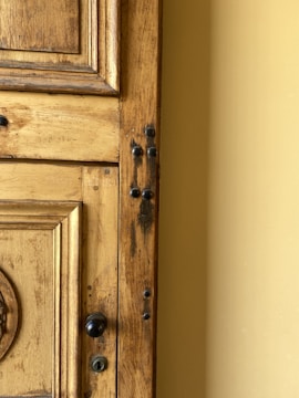 Close-up of a wooden door with natural grain texture in a modern home setting