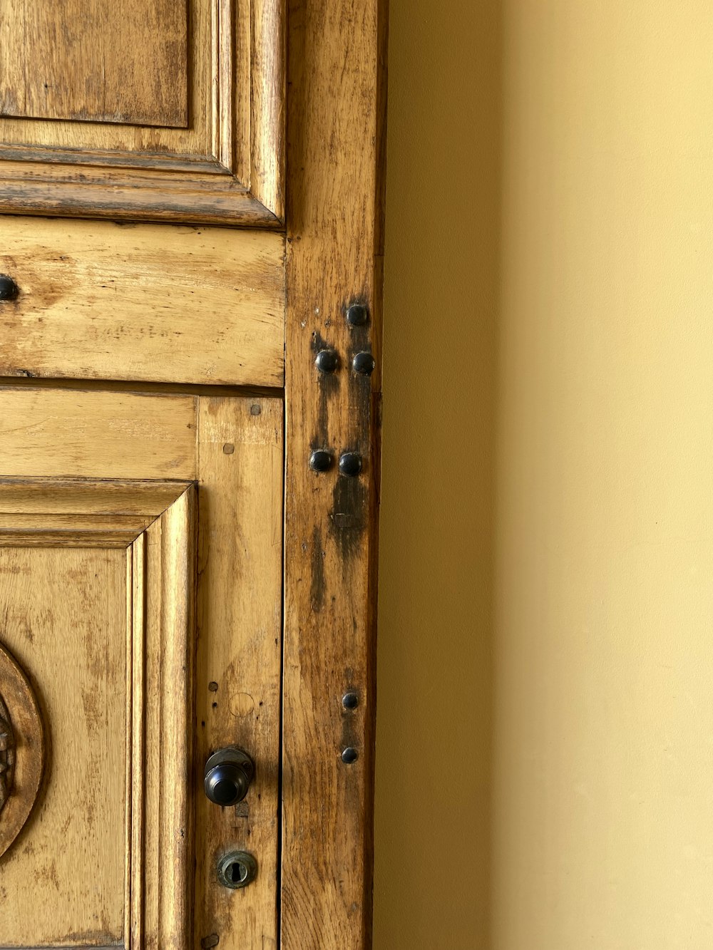 a close up of a wooden door with knobs