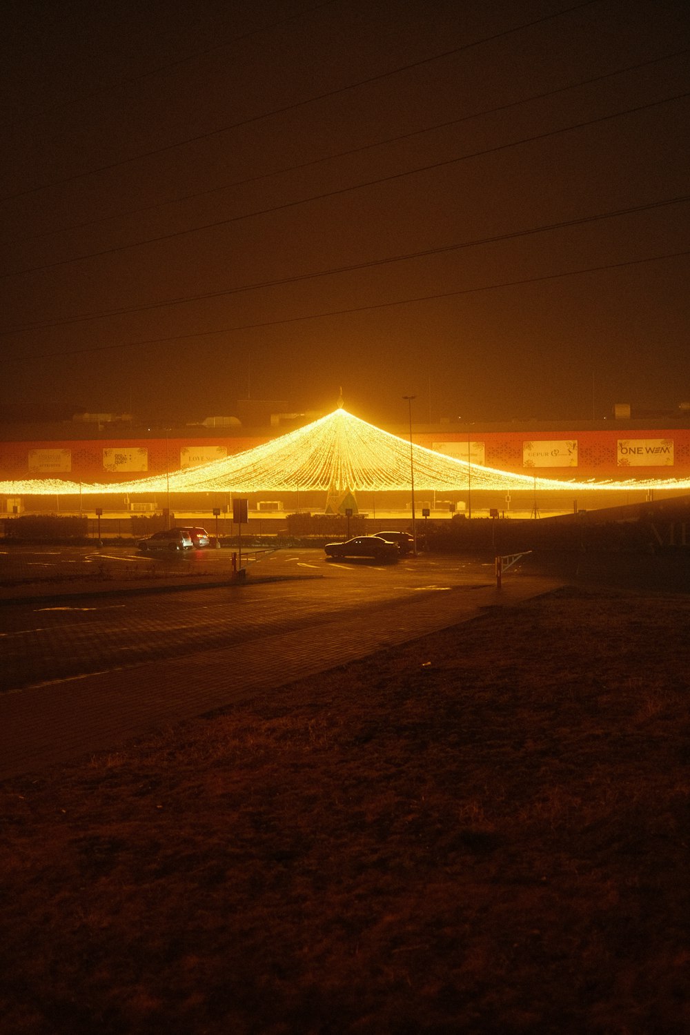 a large circus tent lit up at night