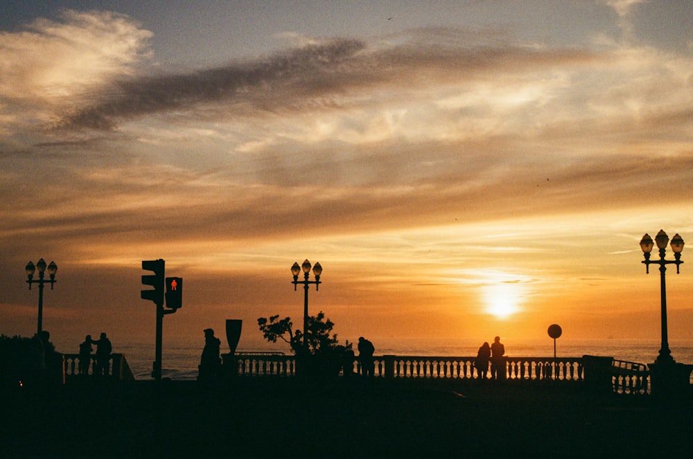 a group of people standing on top of a bridge