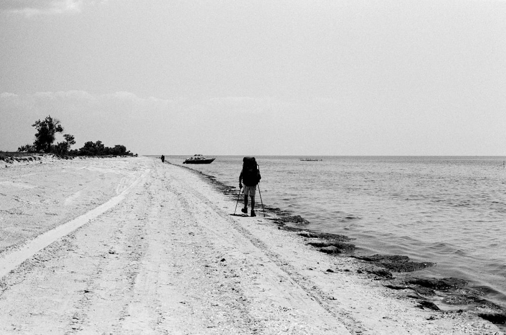 a person standing on a beach next to the ocean