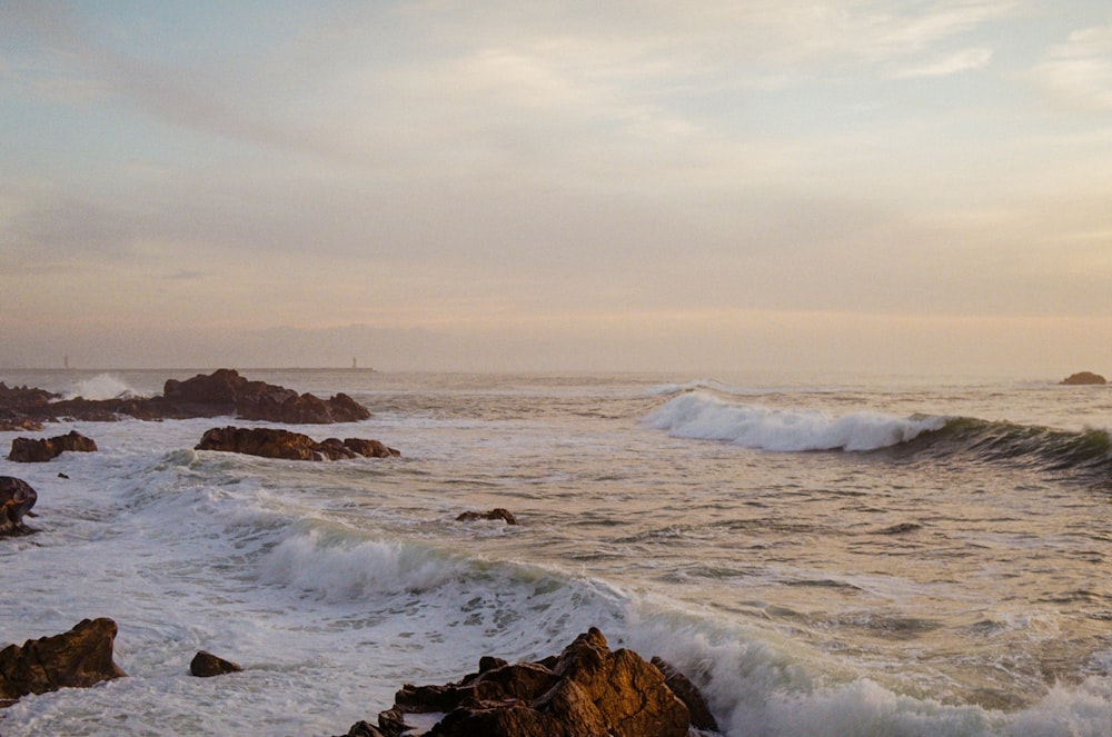 a large body of water near a rocky shore