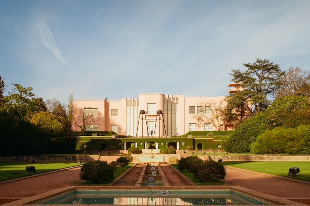 a large building with a fountain in front of it