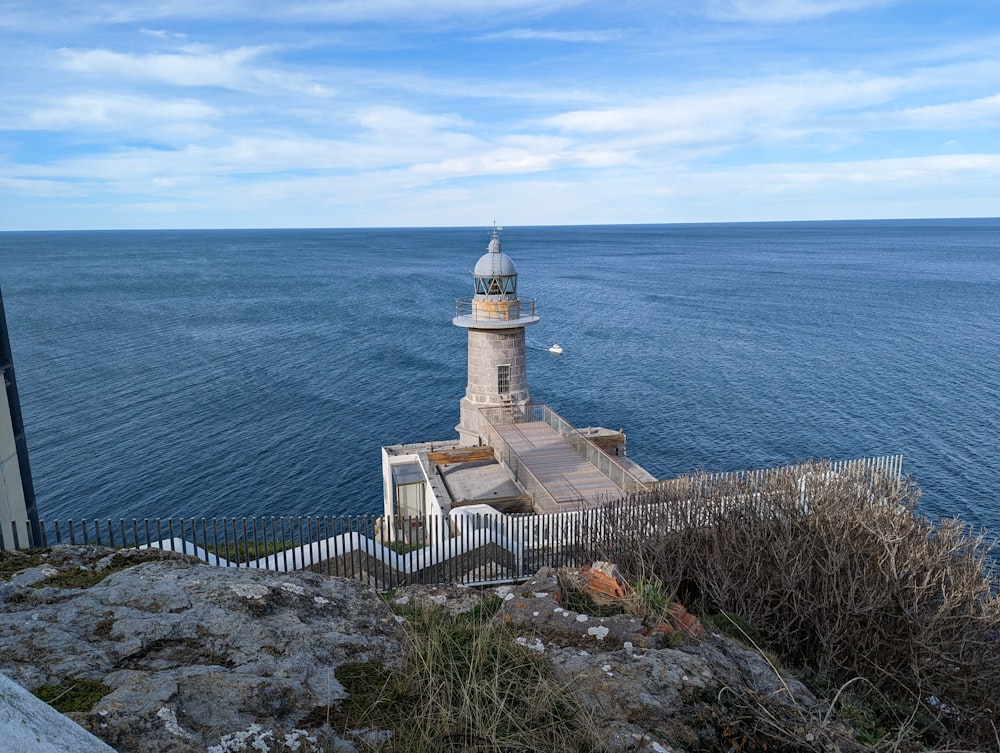 a lighthouse on a cliff overlooking the ocean