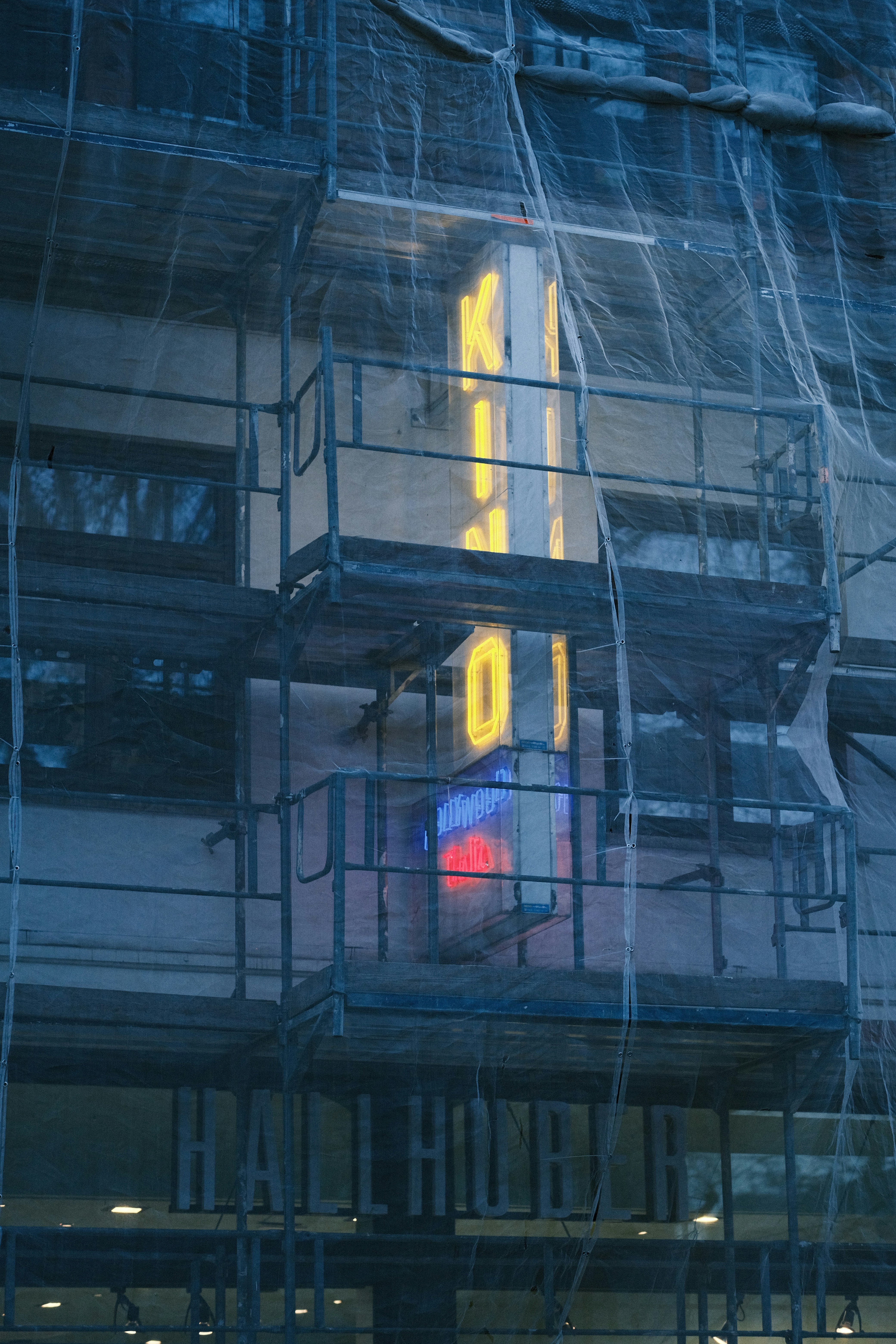 a building with scaffolding around it and a clock on the side of it