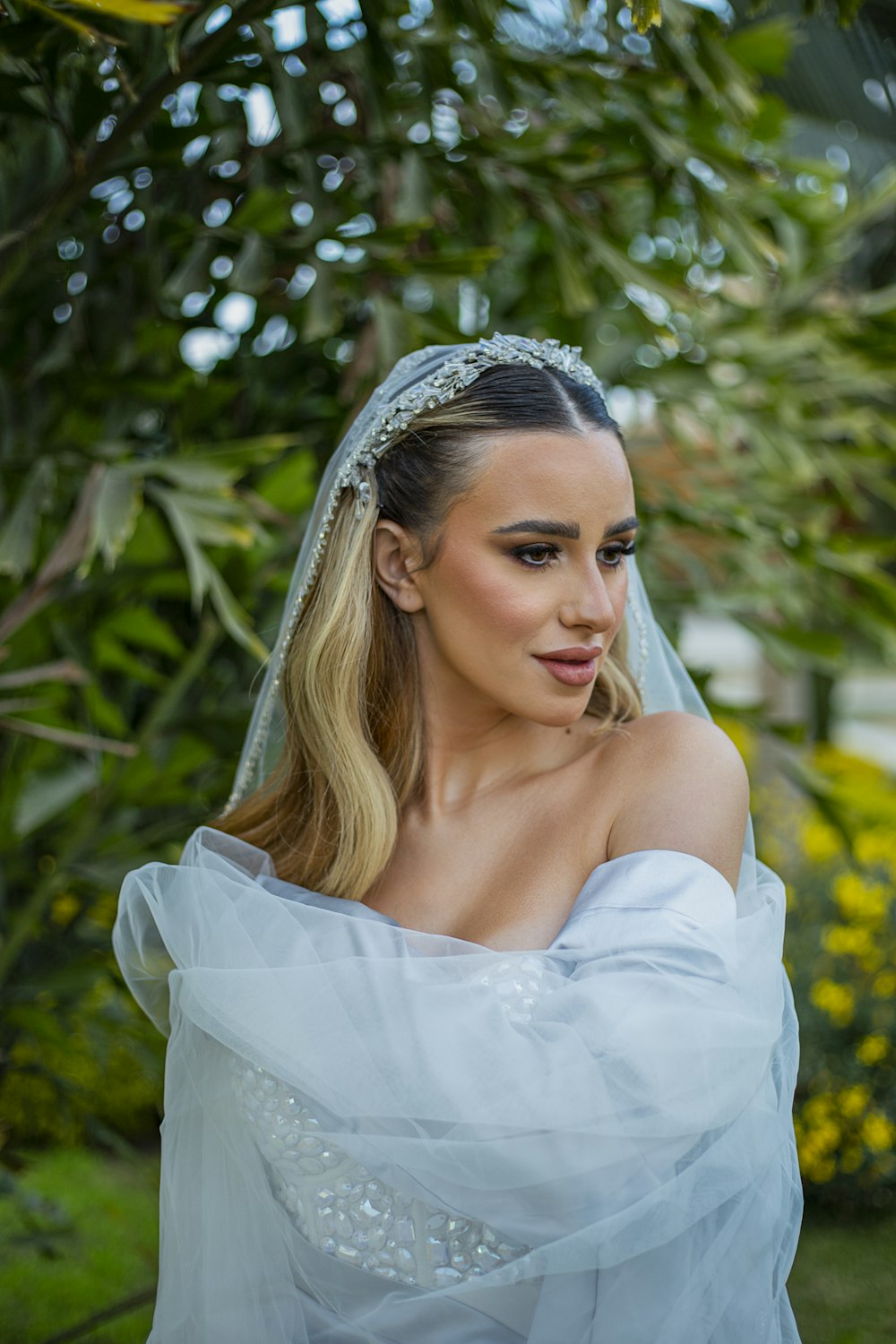 a woman wearing a veil and a wedding dress