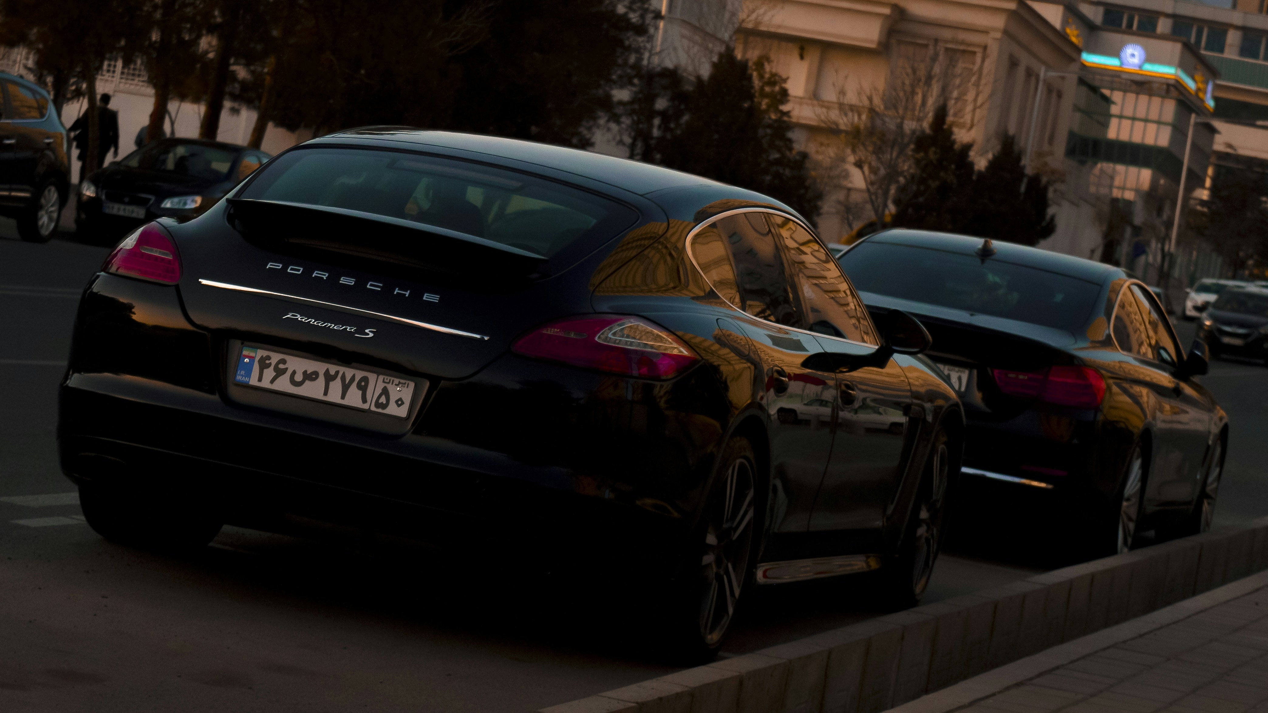 a couple of black cars parked next to each other