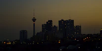 City skyline at dusk representing international business connections.