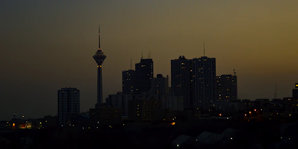 Elegant city skyline at dusk with illuminated office buildings.