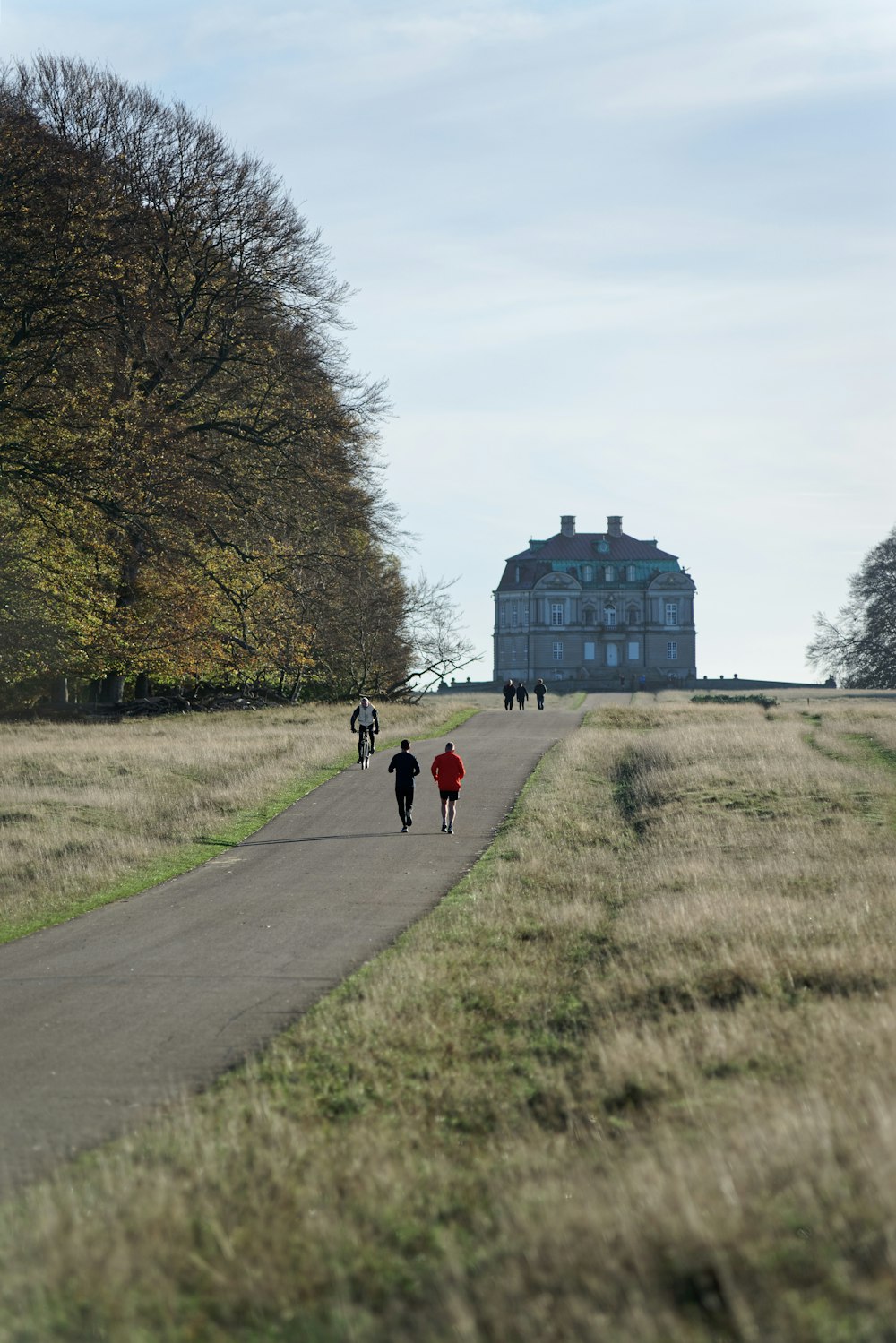 a group of people walking down a road