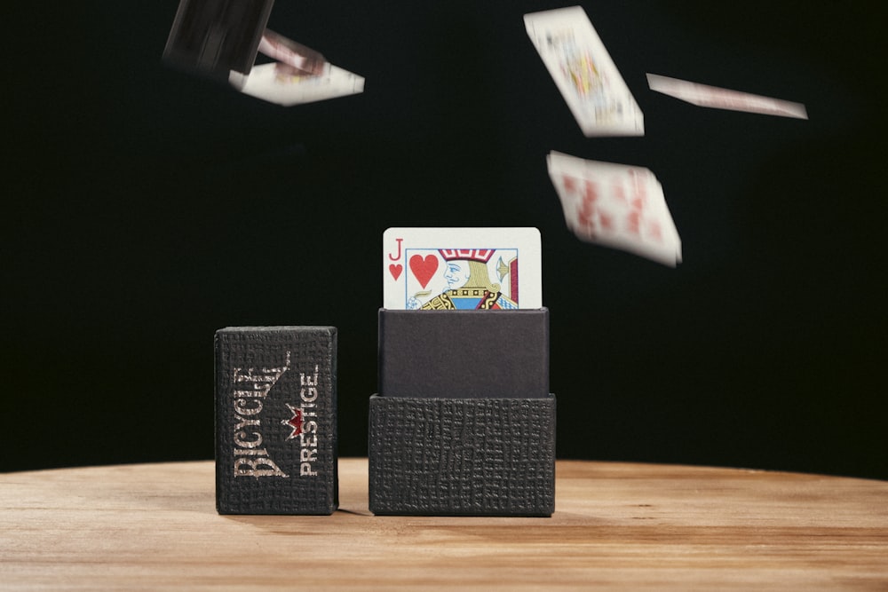 a wooden table topped with cards and dice