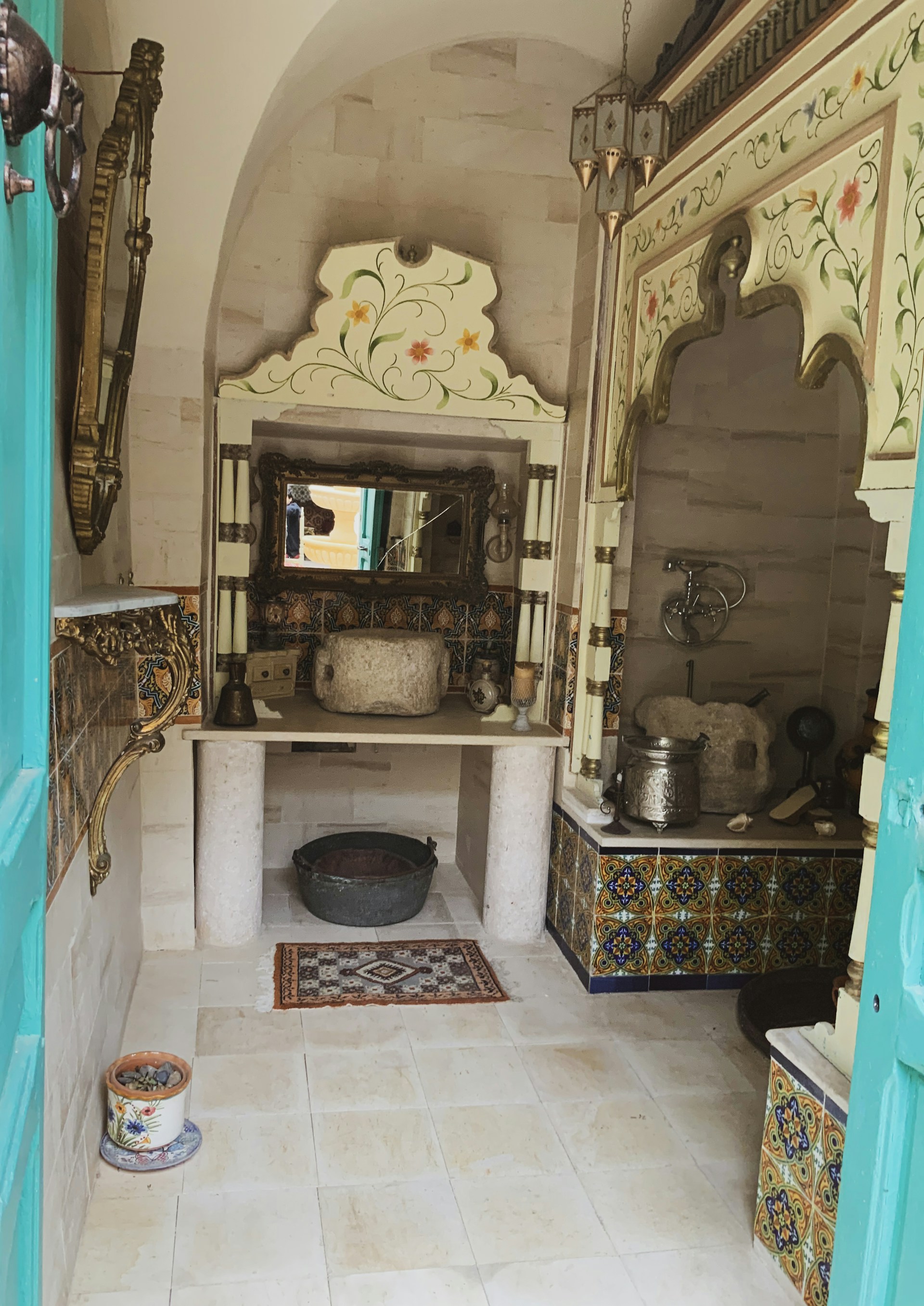 A traditional Moroccan bath setup featuring warm steam and elegant tiles, showcasing the authentic hammam experience offered.
