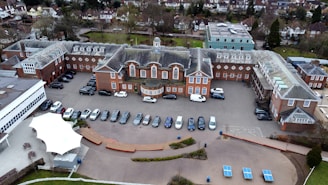 an aerial view of a parking lot with cars parked in it