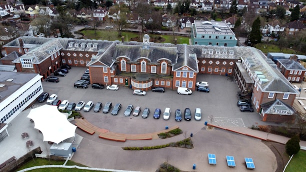 an aerial view of a parking lot with cars parked in it