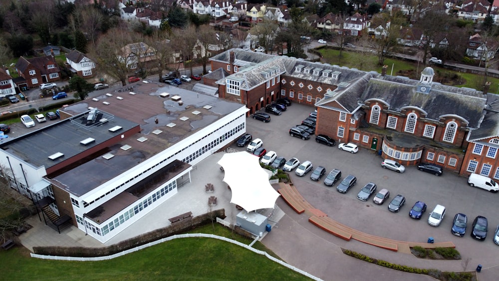 an aerial view of a parking lot with cars parked in it