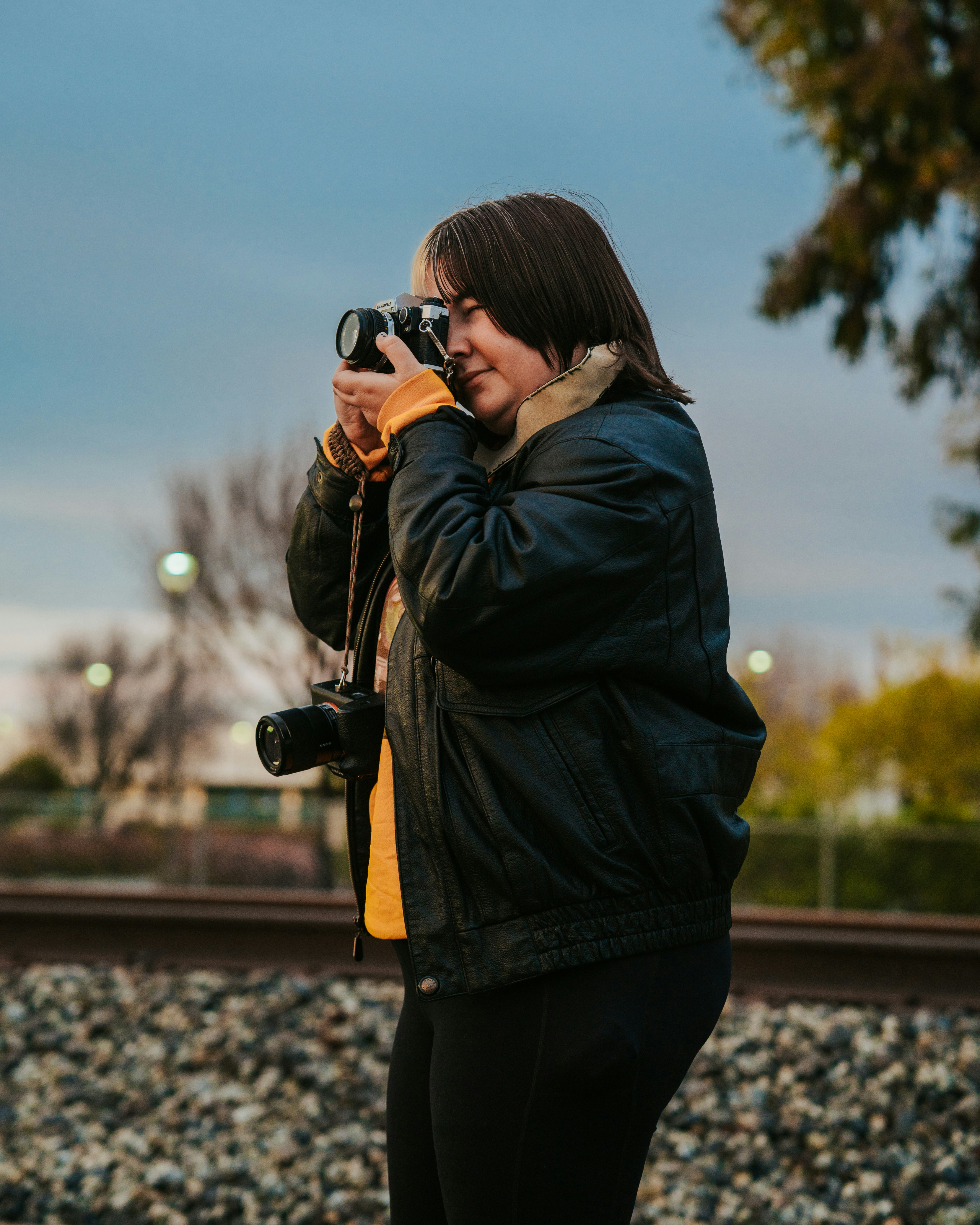 a woman taking a picture of herself with a camera