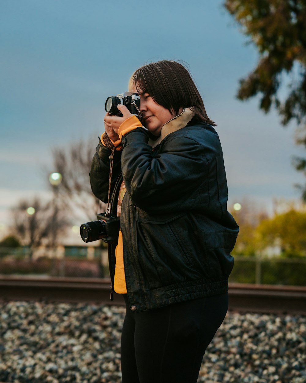 a woman taking a picture of herself with a camera