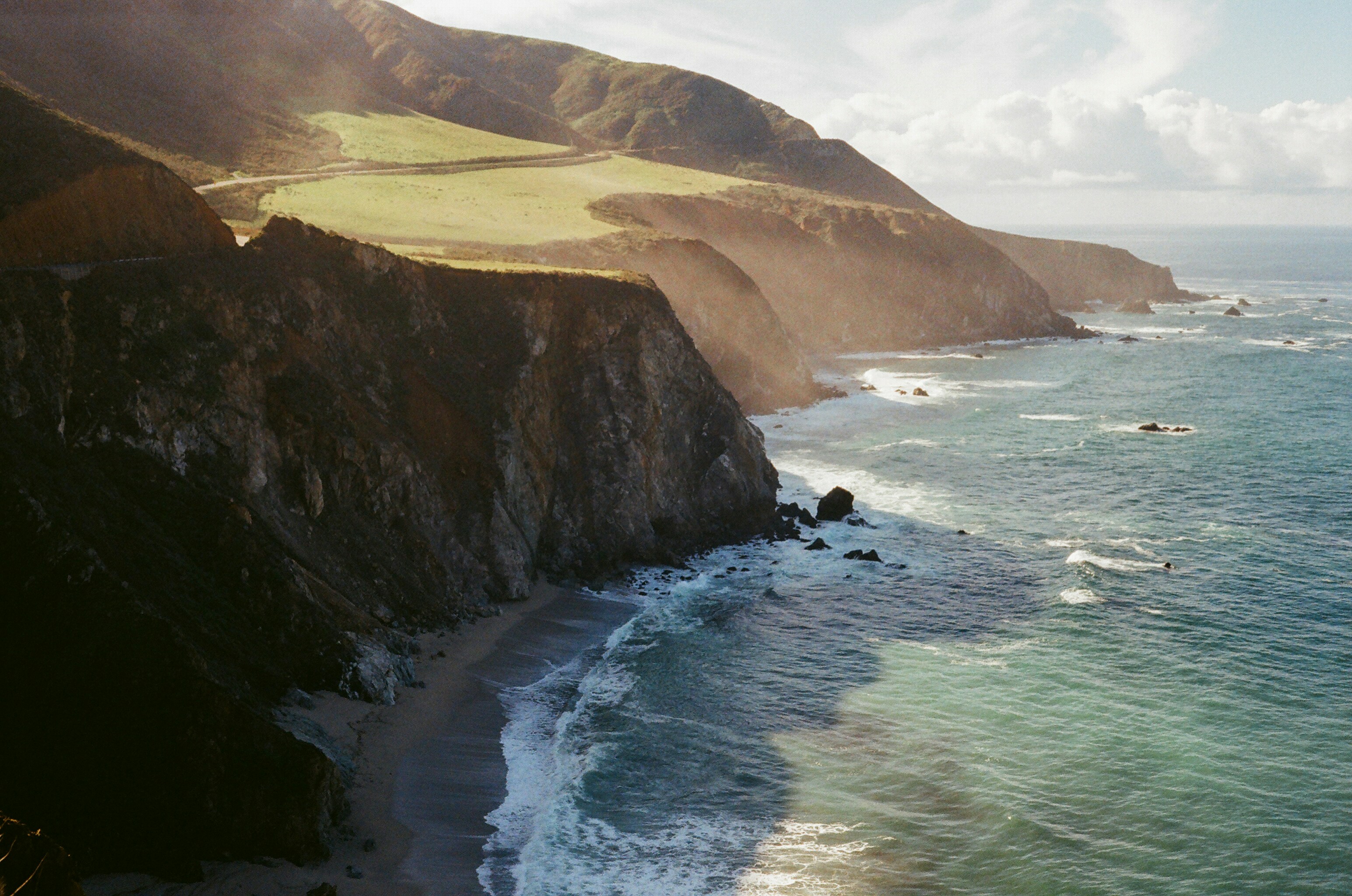 a scenic view of the ocean and cliffs
