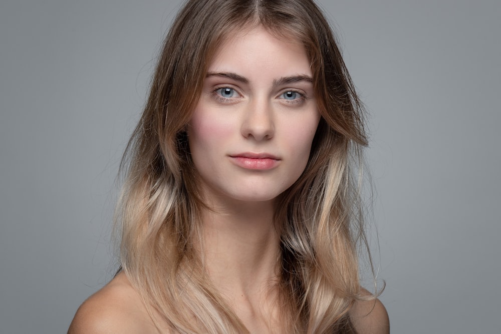 a woman with long blonde hair and blue eyes