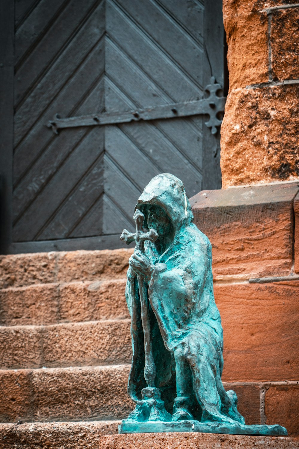 a statue of a person sitting on a step