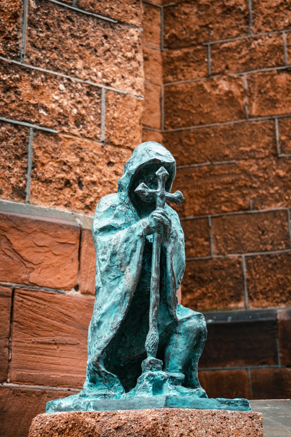 a statue of a person sitting on a bench