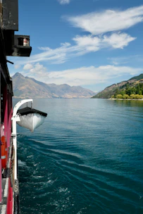 Elegant boat cruising near the Borromean Islands under a clear blue sky.