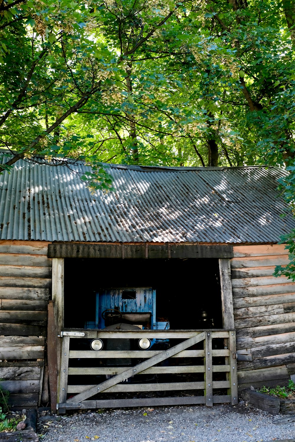 an old log cabin with a metal roof