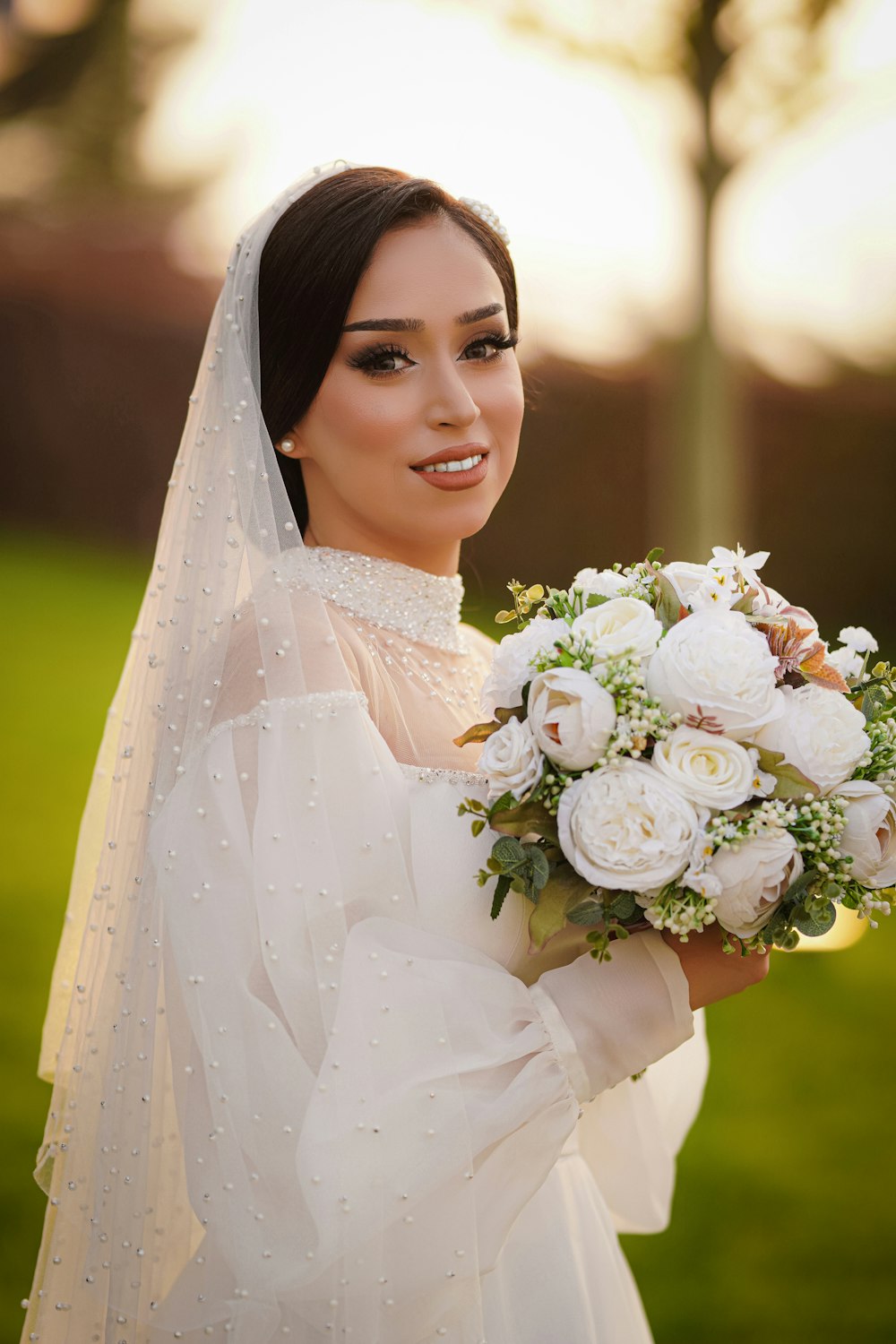 a woman in a wedding dress holding a bouquet of flowers