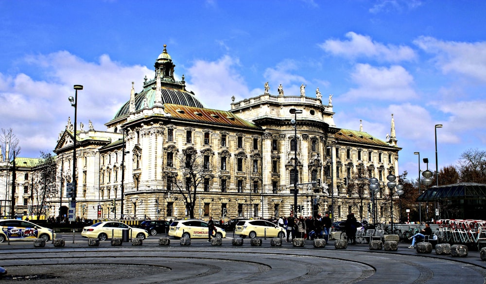 a large building with a lot of cars parked in front of it