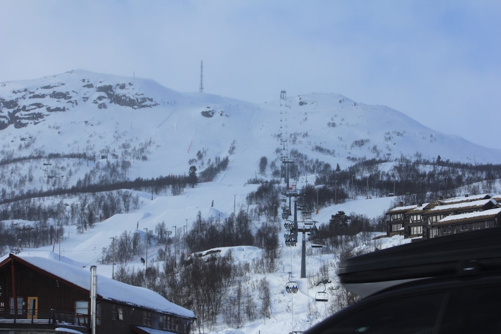 a snowy mountain with a ski lift in the distance