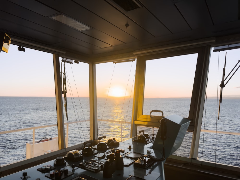 the sun is setting over the ocean from a boat