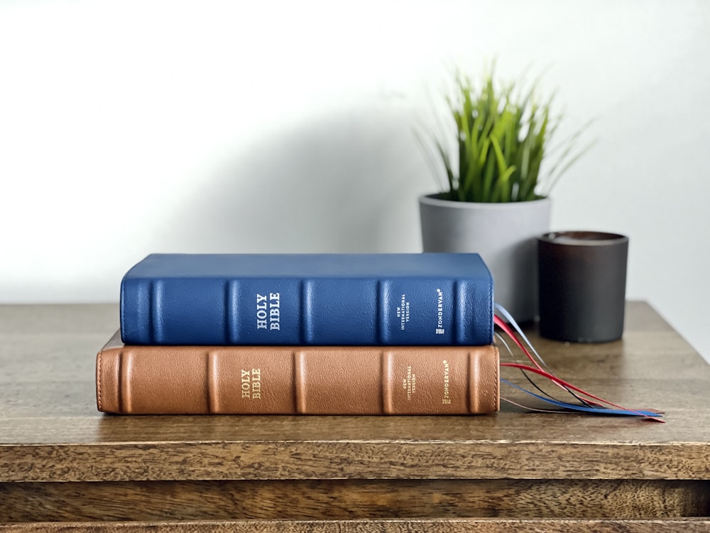 a couple of books sitting on top of a wooden table