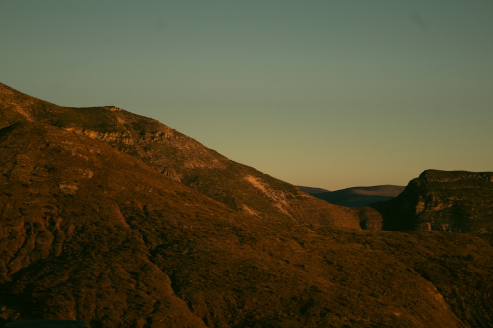 a view of a mountain with a sky in the background