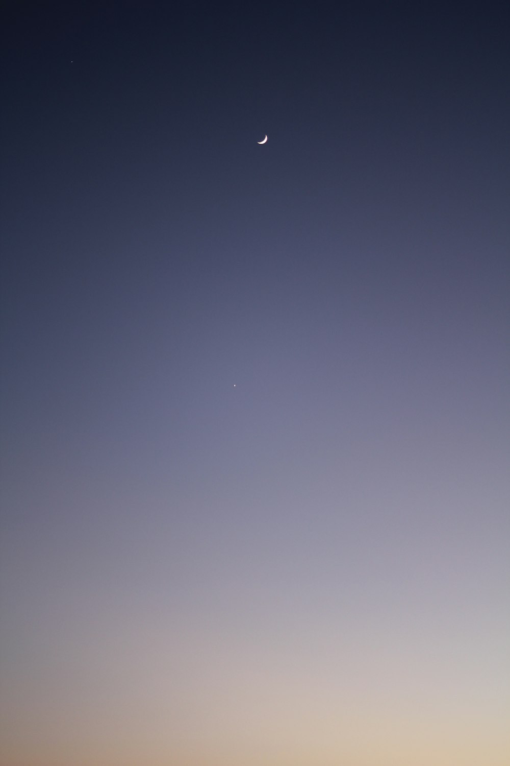 a view of the moon and a distant object in the sky