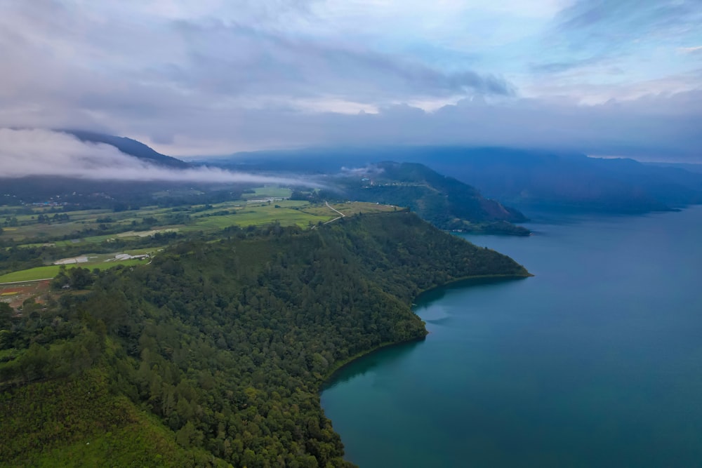 a large body of water surrounded by lush green trees