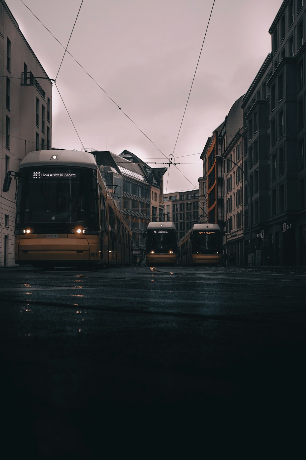 a couple of buses that are sitting in the street