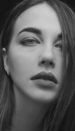 Black and white still from a dramatic short film showing a close-up of a thoughtful face.