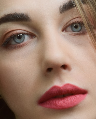 Soft-focus image of a female model emphasizing delicate, precise eyeliner enhancing her eyes.