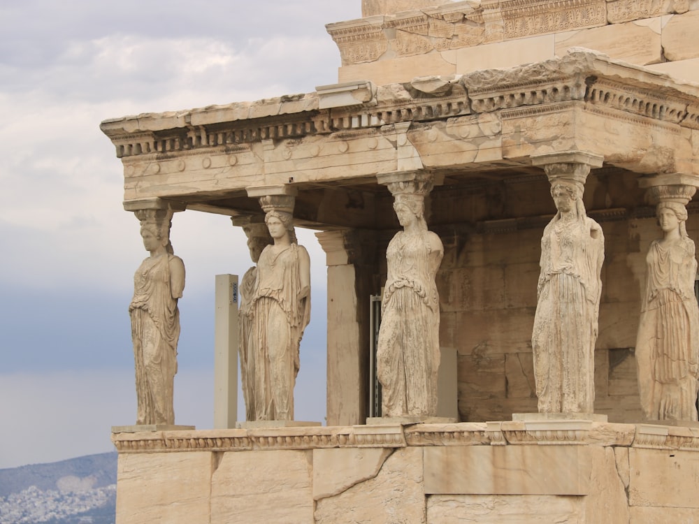 a group of statues on the side of a building