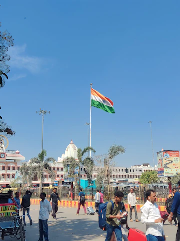 a group of people walking around a city square
