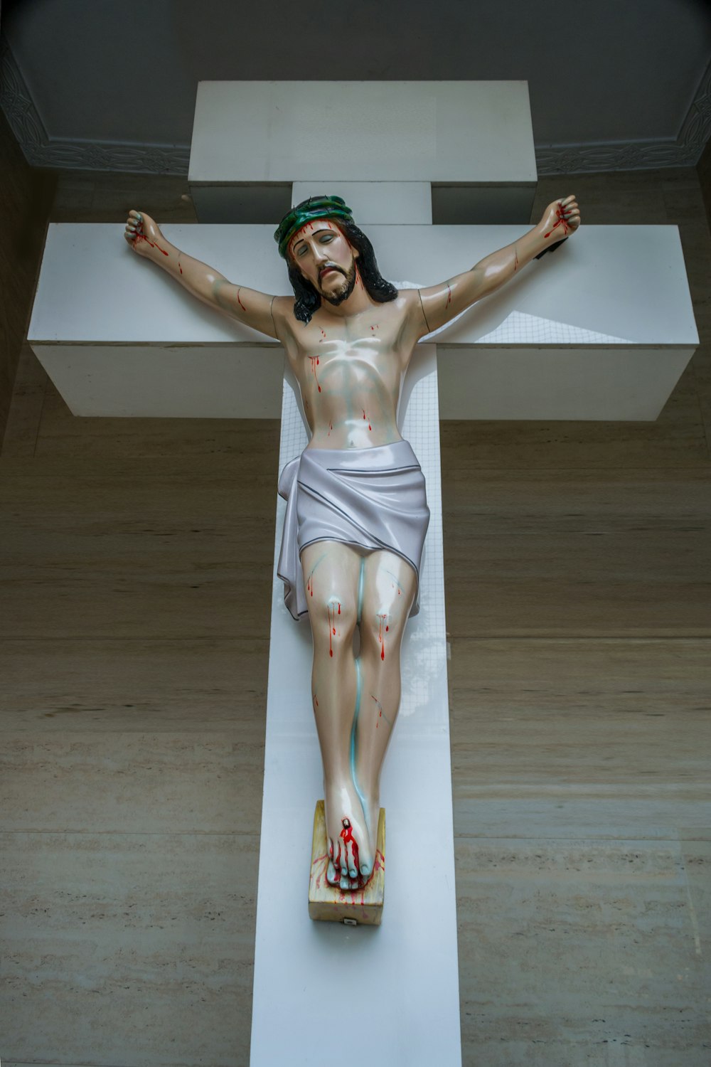 a statue of jesus on a cross in a room